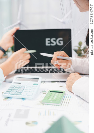 Business people working on sustainable innovation project. renewable energy concept. Teamwork Meeting, partner on model building company office technology, based green businesses and global warming. Business people working on sustainable innovation project. renewable energy concept. Teamwork Meeting, partner on model building company office technology, based green businesses and global warming. 127884747