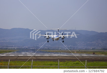 Take-off and landing at Osaka International Airport (Itami Airport) Take-off and landing at Osaka International Airport (Itami Airport) 127884792