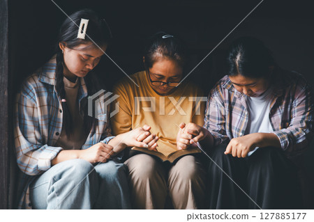 Close up group christians hands pray to God with spiritual faith on holy bible in catholic church. religion worship prayer ask god bless grace jesus believe. Christianity religion prayer holy worship 127885177