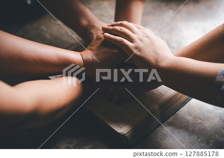 Close up group christians hands pray to God with spiritual faith on holy bible in catholic church. religion worship prayer ask god bless grace jesus believe. Christianity religion prayer holy worship Close up group christians hands pray to God with spiritual faith on holy bible in catholic church. religion worship prayer ask god bless grace jesus believe. Christianity religion prayer holy worship 127885178