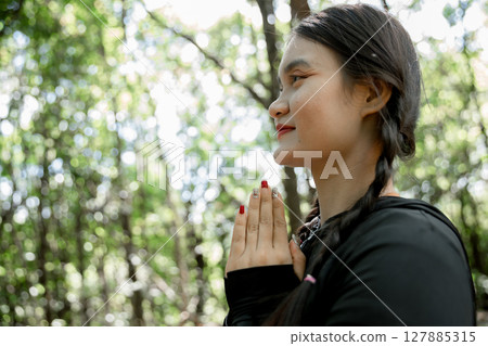 Grateful woman having HOPE praying to God. Spiritual girl smiling to sky. Happy female being thankful. Spiritual girl praying with hope. Positive asian young woman feeling hope and faith looking up. 127885315