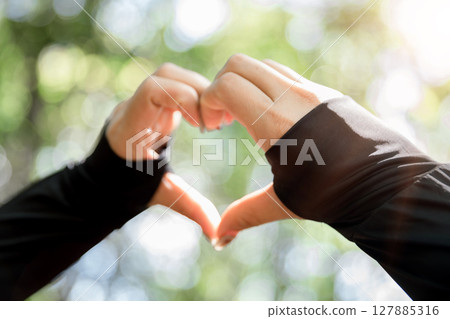 Young woman hand reaching for mountains. Spiritual girl smiling to sky. Happy female being thankful. Spiritual girl praying with hope. Positive asian young woman feeling hope and faith looking up. Young woman hand reaching for mountains. Spiritual girl smiling to sky. Happy female being thankful. Spiritual girl praying with hope. Positive asian young woman feeling hope and faith looking up. 127885316