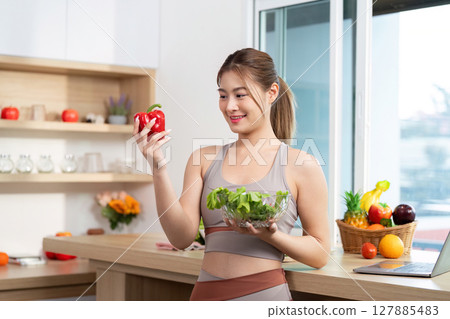 Wellness and Nutrition. Woman choosing fresh red bell pepper for healthy meal. Wellness and Nutrition. Woman choosing fresh red bell pepper for healthy meal. 127885483