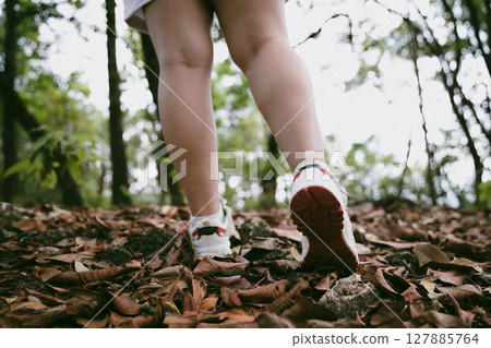 Hiking action on mountain grass trail path. Close up of female hiker shoe. adventurous lifestyle of hiker and backpack to travel and trek mountain, enjoy every walk and hike part of thrilling journey Hiking action on mountain grass trail path. Close up of female hiker shoe. adventurous lifestyle of hiker and backpack to travel and trek mountain, enjoy every walk and hike part of thrilling journey 127885764