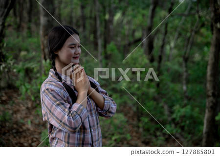 Grateful woman having HOPE praying to God. Spiritual girl smiling to sky. Happy female being thankful. Spiritual girl praying with hope. Positive asian young woman feeling hope and faith looking up. 127885801
