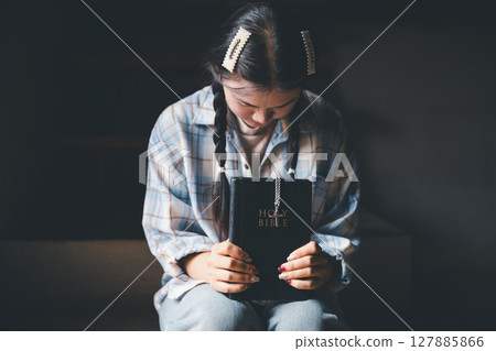 Christian woman reading bible in ancient Catholic temple. Reading Holy Bible in temple. Concept for faith, spirituality and religion. Peace, hope, Christians with holy book for worship and faith Christian woman reading bible in ancient Catholic temple. Reading Holy Bible in temple. Concept for faith, spirituality and religion. Peace, hope, Christians with holy book for worship and faith 127885866
