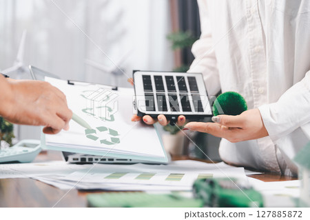 Business people working on sustainable innovation project. renewable energy concept. Teamwork Meeting, partner on model building company office technology, based green businesses and global warming. Business people working on sustainable innovation project. renewable energy concept. Teamwork Meeting, partner on model building company office technology, based green businesses and global warming. 127885872