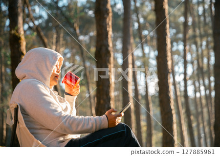 Remote work technology online close up communication smart phone laptop telephone digital travel brown nature sunlight camp beverage morning sit drink coffee tent orange outlying concept background. Remote work technology online close up communication smart phone laptop telephone digital travel brown nature sunlight camp beverage morning sit drink coffee tent orange outlying concept background. 127885961