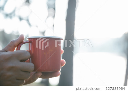 Business concept of cafe focuses on nurturing coffee in harmony with nature, organic seed create warm cup caffeine, background green fresh great outdoor. aromatic drink, rich aroma of rising from mug 127885964