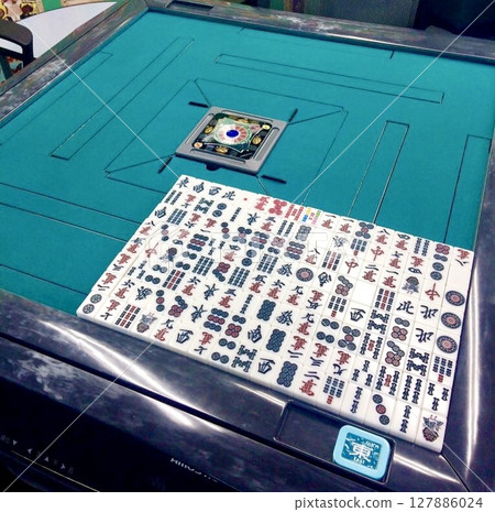 Mahjong tiles on a green cloth mahjong table Mahjong tiles on a green cloth mahjong table 127886024