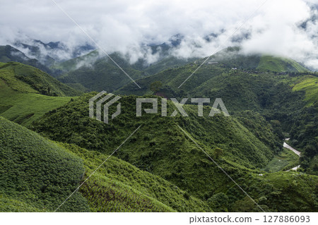 Landscape of Morning Mist with Mountain Layer. mountain ridge and clouds in rural jungle bush forest 127886093