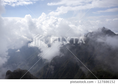 Landscape of Morning Mist with Mountain Layer. mountain ridge and clouds in rural jungle bush forest 127886152