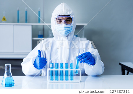 Scientist man holding sample blood test tube in science laboratory. Doctor clinic healthcare technician lab testing blood sample diagnosis. Asian man scientist working in hiv testing medical lab. 127887211