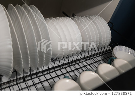Dishes Drying in a Kitchen Rack After a Wash in a Modern Home 127888571
