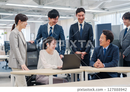Office workers working very cheerfully as team members 127888942