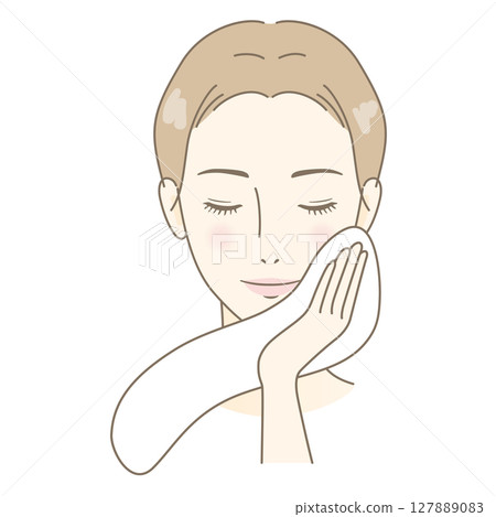 A woman wiping her face with a towel after washing her face A woman wiping her face with a towel after washing her face 127889083