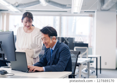 Boss and young woman having fun in the office Boss and young woman having fun in the office 127889170