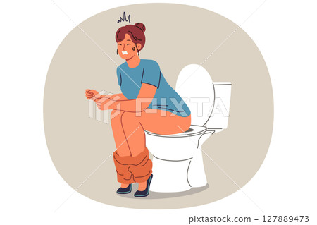 Woman poops sitting on toilet and suffers from constipation caused by indigestion or stomach 127889473