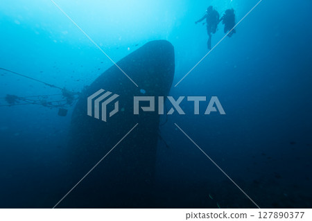 Two Divers Explores the Relax Wreck at Dive Site on the Island of Bali, Indonesia. 127890377