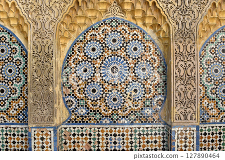 Ornamental and colorful arabesque carvings, mosaic tiles, zellige, medina of Tangier, Morocco Ornamental and colorful arabesque carvings, mosaic tiles, zellige, medina of Tangier, Morocco 127890464