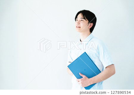 A man working as a caregiver holding a file 127890534
