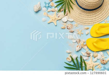 Beach accessories creating summer holiday mood on blue background Beach accessories creating summer holiday mood on blue background 127890601