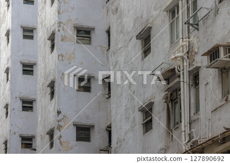 June 29 2025 Urban Apartment Exterior with Peeling Paint and Multiple Small Windows 127890692