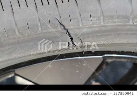 Close-up of the damage caused by a burst tire 127890941