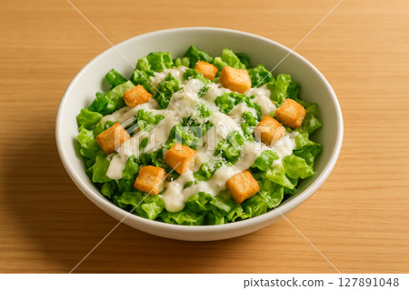 Simple Caesar salad with dressing 127891048