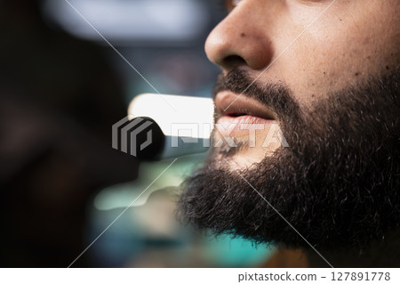 Intelligence agency expert using headset mic to call in air strikes on enemy troops. Close up of military dispatcher in headquarters making call to request air support for ground soldiers 127891778