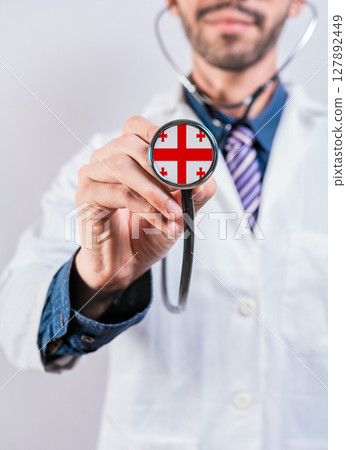 Georgia health and medical insurance concept. Georgia healthcare system, doctor holding stethoscope 127892449