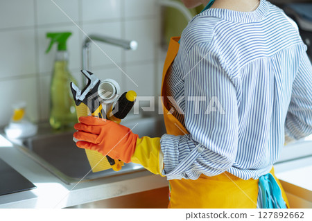 Woman Ready for Kitchen Plumbing Repair 127892662