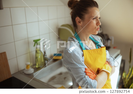Frustrated woman reacts to persistent kitchen clog 127892754