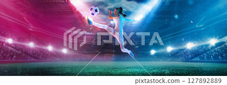 Girl kicking soccer ball mid-air in neon lights on 3D football field. Banner 127892889