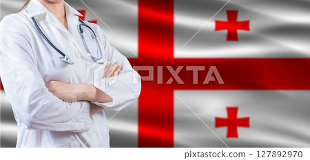 Doctor with crossed arms on Georgia flag. Georgia health and care concept. Female doctor on Georgia flag 127892970