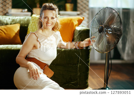 Summer Comfort: Smiling Woman with Fan 127893051