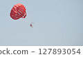 parasailing with red parachute 127893054