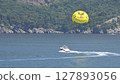 parasailing with yellow parachute 127893056