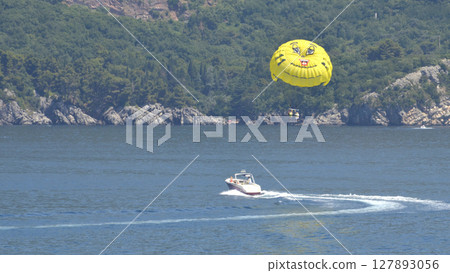 parasailing with yellow parachute 127893056