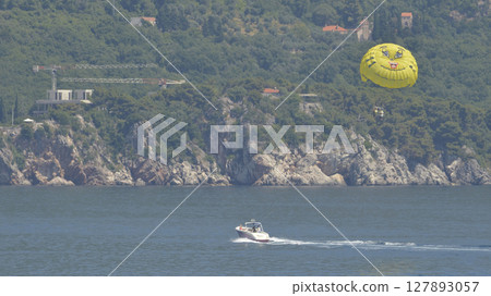 parasailing with yellow parachute 127893057