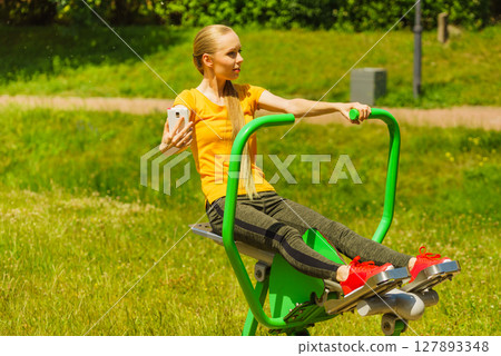 Girl doing exercises outdoor, taking selfie 127893348