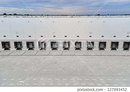 Logistics warehouse exterior with loading platforms, aerial view 127893452