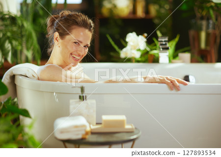 Cheerful Woman Relaxing in a Bubbly Bath Cheerful Woman Relaxing in a Bubbly Bath 127893534