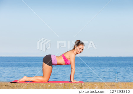 Woman with water after workout 127893810