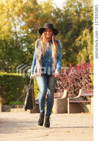 Fashionable model posing in park Fashionable model posing in park 127893865