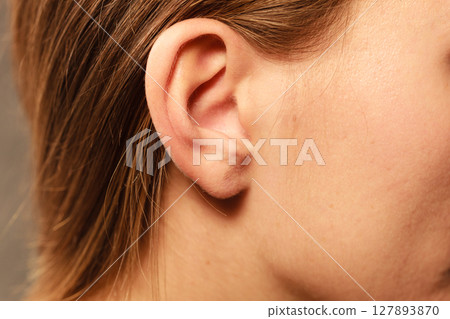 Close up on female ear Close up on female ear 127893870