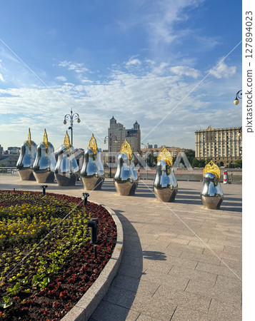 Colorful sculptures line a city walkway in bright sunlight Colorful sculptures line a city walkway in bright sunlight 127894023