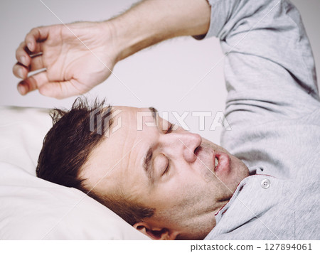 Man waking up in bed Man waking up in bed 127894061
