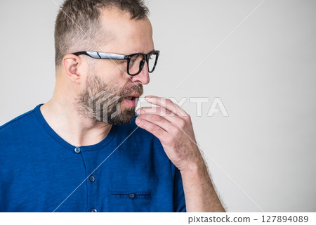 Adult clever guy wearing eyeglasses having thinking, focused face expression. Adult clever guy wearing eyeglasses having thinking, focused face expression. 127894089