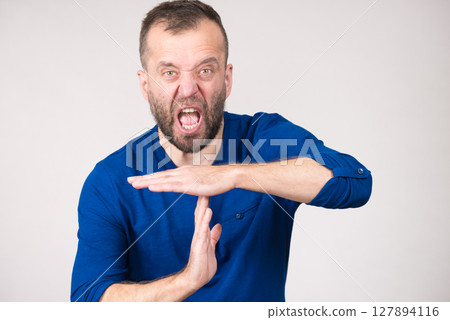 Man showing time stop gesture Man showing time stop gesture 127894116